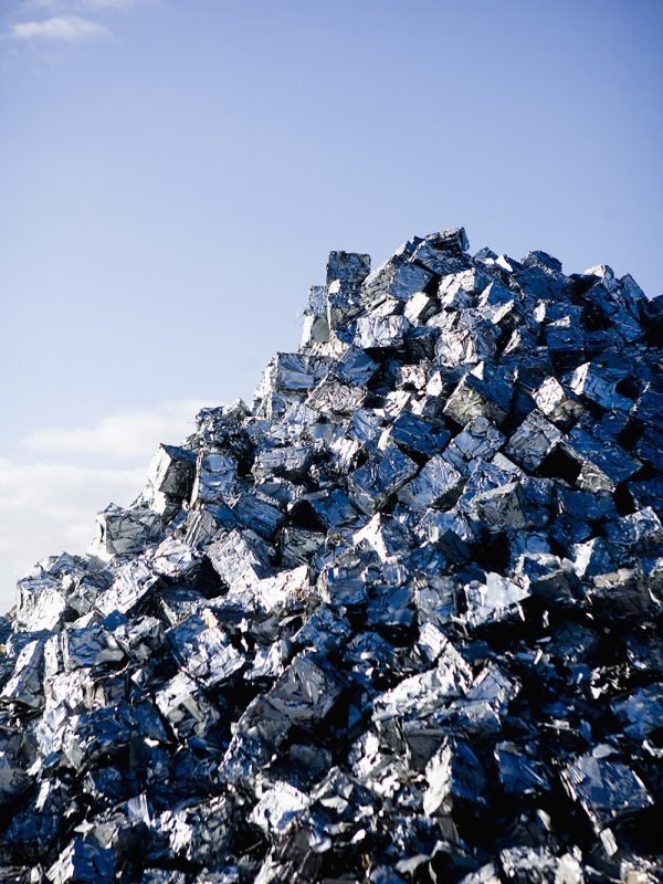 Heap of metal scrap against blue sky